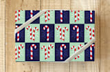 "Candy Canes and Snowflakes" - Wrapping Paper in Festive Red by Lisa Travis - Front