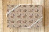 "Krafty Pines" - Wrapping Paper in Pinecone Brown by Amy Ngo - Front