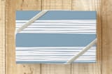 "Stacked Lines Wrap" - Wrapping Paper in Dusty Blue by Amber Barkley - Front