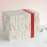 "Merry Stack" - Wrapping Paper in Eggnog by Ana Sharpe - Front