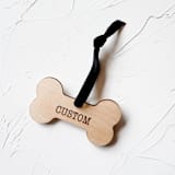 "Personalized Wooden Dog Bone Ornament" - Ornaments in beige by Left Grain
