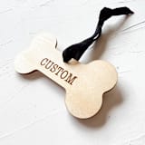 "Personalized Wooden Dog Bone Ornament" - Ornaments in beige by Left Grain