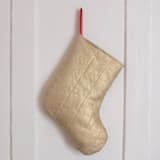 "Small Gold Quilted Stocking with Red Ribbon Hook Detail" - Stockings in gold by Quiet Goods