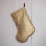 "Gold Quilted Stocking with Red Ribbon Hook Detail" - Stockings in gold by Quiet Goods