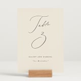 "Scripted Names" - Table Numbers in Ecru by Hooray Creative - Displayed (stand not included)