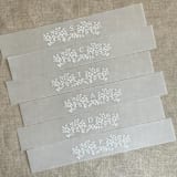 "Floral garland initial belly band for 5x7 Card | pack of 10" - Belly Bands in white by Ivory Invitations