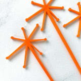 "Starburst Stir Sticks - Orange (Set of 25)" - Stir Sticks in pink by Atomic Kraftworks