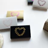 "Wild at Heart Matchbox, Gold on White" - Matchbooks and Matches in white by Jessica Cunningham