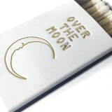 "Over the Moon Matchbox, Gold on White" - Matchbooks and Matches in white by Jessica Cunningham