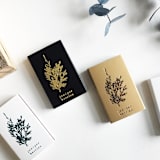 "Juniper Berries Matchbox, Gold on Black" - Matchbooks and Matches in gold by Jessica Cunningham