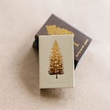"Noble Fir Tree Matchbox, Gold on Sand" - Matchbooks and Matches in beige by Jessica Cunningham