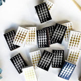 "Phases of the Moon Matchbox, Gold on White" - Matchbooks and Matches in white by Jessica Cunningham