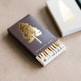 "Lodgepole Pine Tree Matchbox, Gold on Brown" - Matchbooks and Matches in brown by Jessica Cunningham