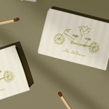"Tandem Bike Customizable Matchboxes | Set of 50" - Matchbooks and Matches in green by Paper Haven