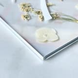 "Silver-Lined Pressed Flower Table Number, White" - Table Numbers in silver by Jasmine Jhunjhnuwala