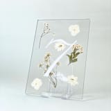 "Silver-Lined Pressed Flower Table Number, White" - Table Numbers in silver by Jasmine Jhunjhnuwala