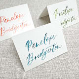 "Custom place cards with watercolor lettering | Tent place cards with modern calligraphy" - Place and Escort Cards in multicolorassorted-colors by Maria Ferrer G.