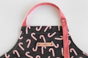 "Assorted Candy Canes" - Apron in Black by Hooray Creative - Detail