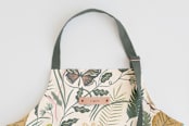 "Folk Butterflies" - Apron in Garden by Morgan Ramberg - Tag in Bodoni Regular