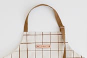 "Montauk" - Apron in Cocoa by Carolyn Nicks - Tag in Bodoni Regular