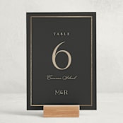 "Timeless Charm" - Foil-Pressed Party Table Numbers in Charcoal by Lucrecia Caporale - Displayed (stand not included)