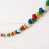 "Holly Berry Felt Ball Garland" - Garlands in multicolor by aubry bennion