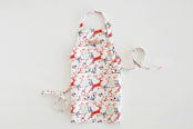 "Jumping Reindeer" - Personalizable Children's Apron in Red by Phrosné Barwood - Personalizable Apron