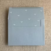 "Steel blue baby ribbon bows envelope liner for A7 square flap envelope | pack of 10" - Envelope Liners in blue by Ivory Invitations
