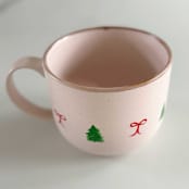 "Hand-Painted Blush Stoneware Mug with Green Christmas Trees and Dainty Red Bows" - Mugs and Teacups in pink by Nicoletta Savod