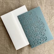 "Dust Blue Lace Lasercut Pocket | Pack of 10 | Envelopes Included" - Invitation Pockets in blue by Ivory Invitations