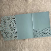 "Dust Blue Lace Lasercut Pocket | Pack of 10 | Envelopes Included" - Invitation Pockets in blue by Ivory Invitations