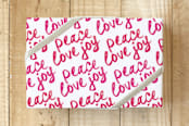 "Brushy Peace Love Joy" - Wrapping Paper in Red Berry by Hooray Creative - Front