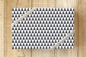 "Tiled Trees" - Wrapping Paper in Charcoal by Maddy Hague - Front