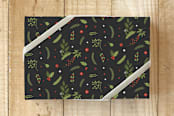 "Holly & Berries Paper" - Wrapping Paper in Deep Grey by Simi Gauba - Front