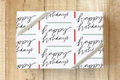 "Lettered holiday" - Wrapping Paper in black by Lea Velasquez - Front