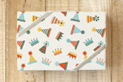 "Party Hats and Crowns" - Wrapping Paper in Mutli-Color on Cream by Carey Copeland - Front