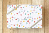 "Birthday Party Banner" - Wrapping Paper in White by Emanuela Carratoni - Front