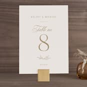 "Emblem" - Table Numbers in Champagne by Everett Paper Goods - Front