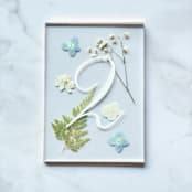 "Gold-Lined Pressed Flower Table Number, Blue" - Table Numbers in red by Jasmine Jhunjhnuwala