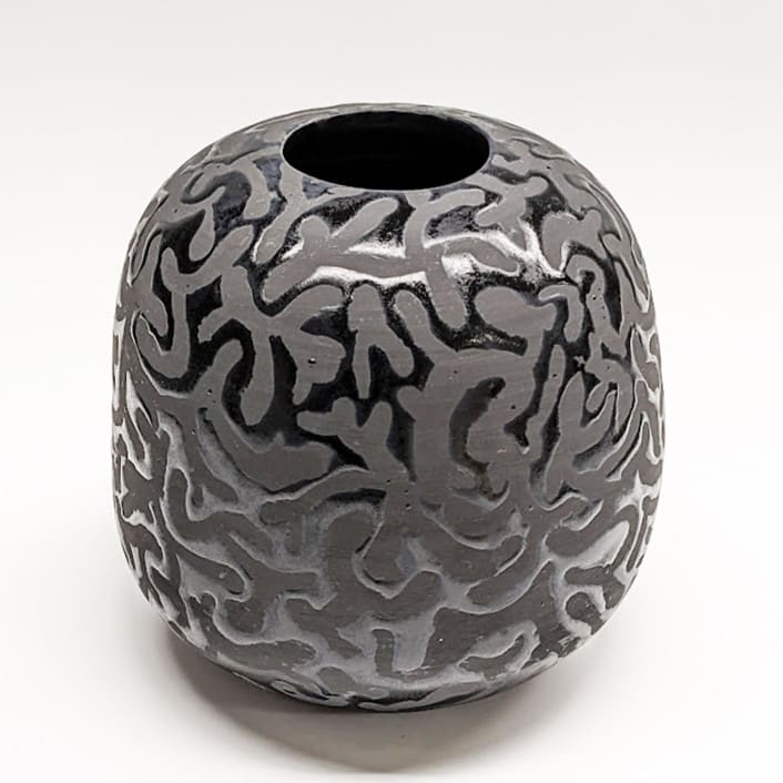 Round black vase with mushroom pattern by Liz Vigoda