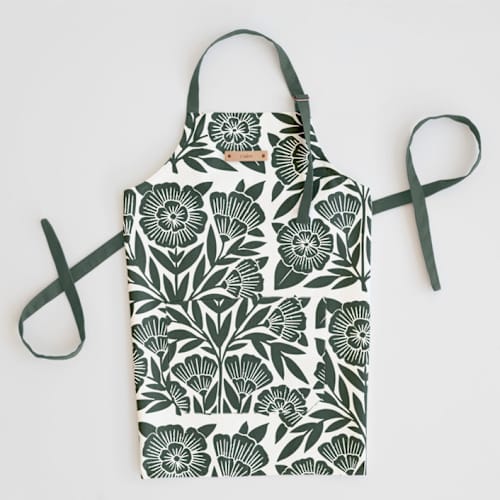 This is a dark teal aprons by Katharine Watson called block print floral in standard