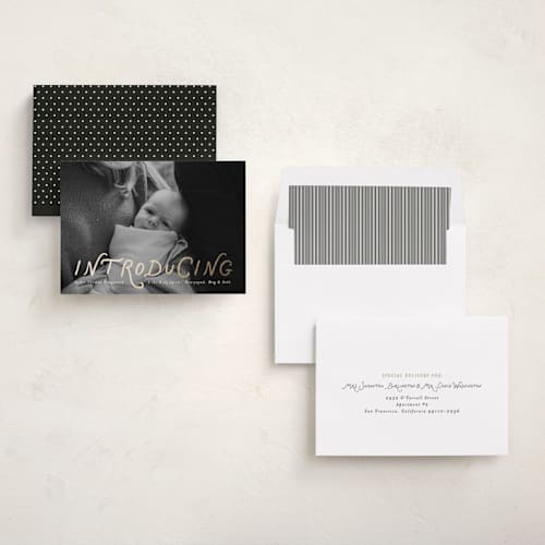 This is a newsprint foil stamped birth announcements with foil pressed by Heather Schertzer called intro printing on recycled smooth signature in standard
