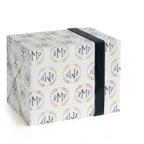 This is a champagne wrapping paper with standard by Erin Deegan called glittering monogram printing on wrapping paper in standard