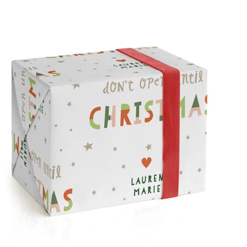 This is a holly wrapping paper with standard by Pixel and Hank called don't open until printing on wrapping paper in standard