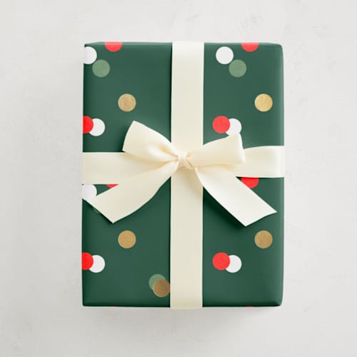 This is a festive wrapping paper by Pixel and Hank called merry dots in standard