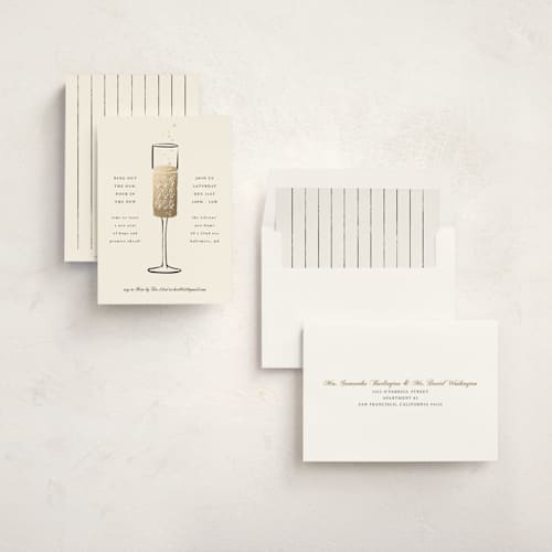 This is a cream holiday party invitations with foil pressed by mo kelley called champagne flute printing on signature in standard