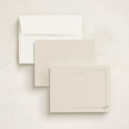 This is a taupe foil stamped stationery with foil pressed by Baumbirdy called corner bows printing on signature in 4.25x5.5