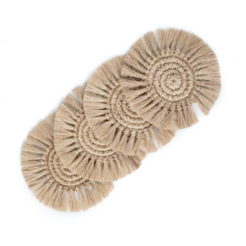 This is a beige tableware by Powered By People called fique fringe coasters - set of 4 in standard
