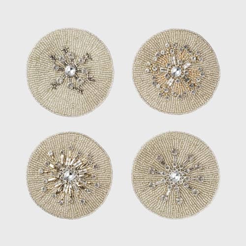 This is a gold tableware by Joanna Buchanan called snowflake coaster in standard