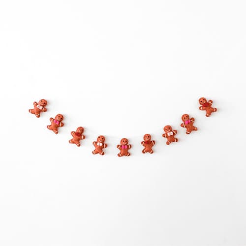 This is a brown holiday decorations by Jollity and Co called jolly gingerbread wool felt garland - set of 1 in standard